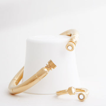 One Seacap bangle and ring on a white background.