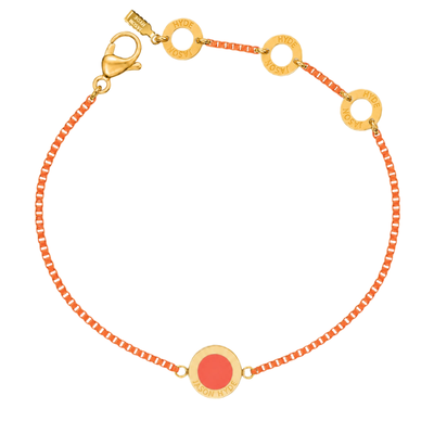 An image showing a Jason Hyde cord bracelet made of textured coral material with gold-tone accents.