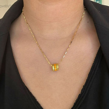 Gold paperclip chain necklace with an orange recycled plastic pendant 