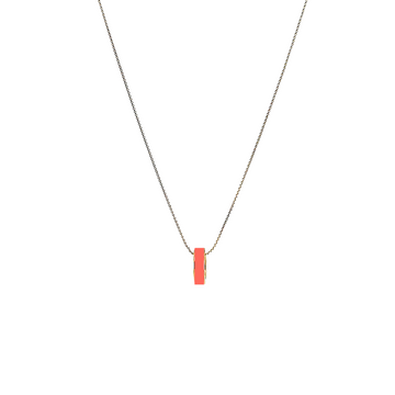 Gold-plated chain necklace with small coral enamel cylindrical pendant by Jason Hyde