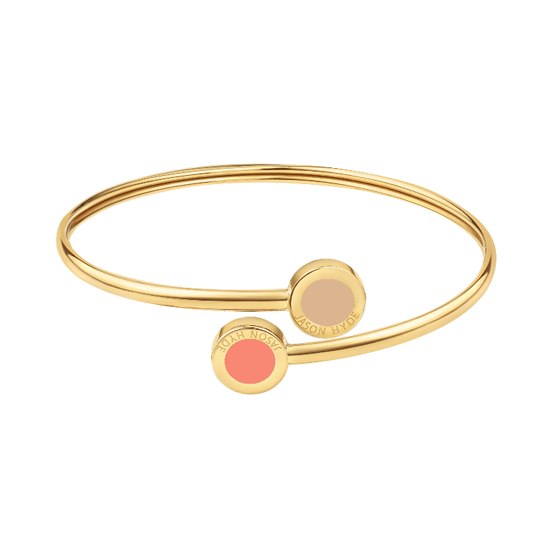 Gold open bangle bracelet with beige and coral enamel charm and minimalist design.