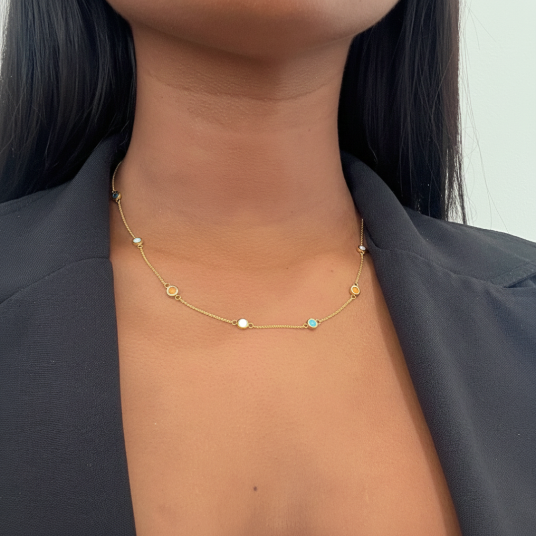 Gold-tone station necklace with multi-colored circular enamel charms.