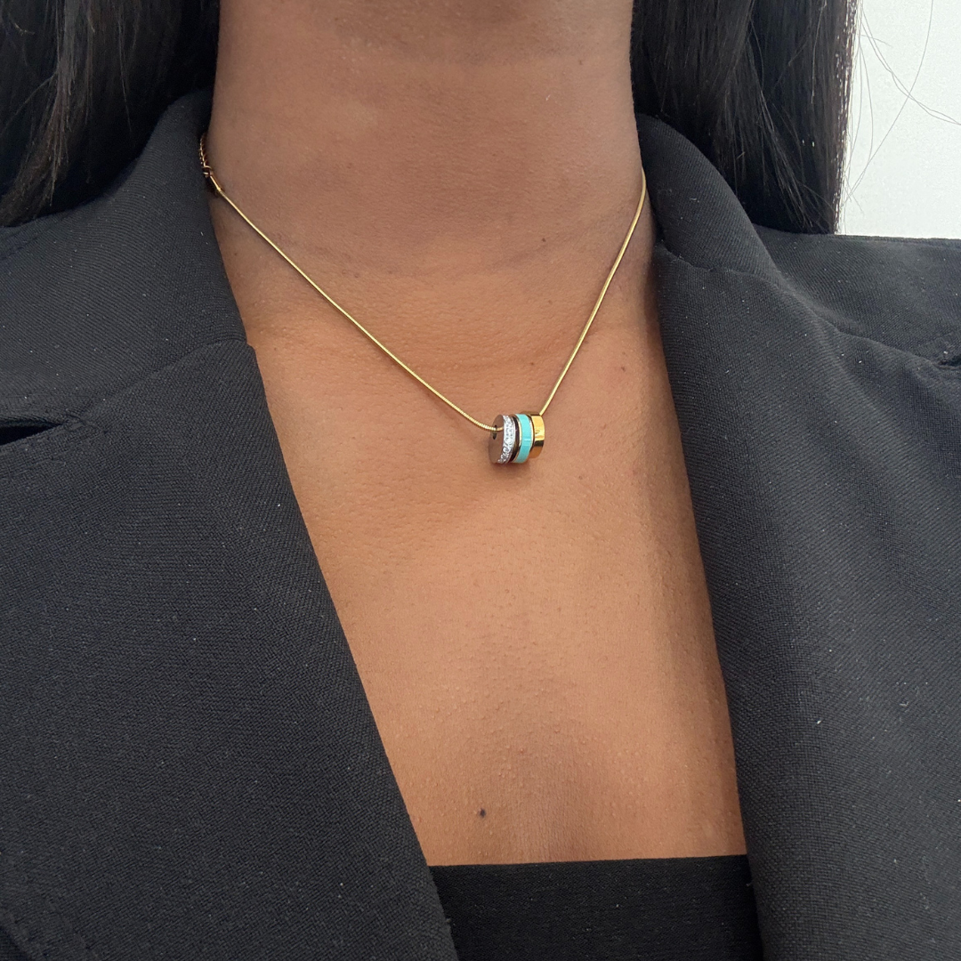 Elegant triple ring pendant necklace in gold-tone with white enamel and pave accents