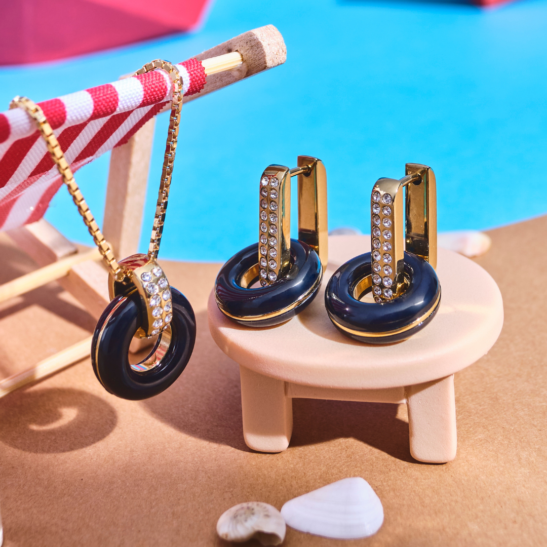 Jason Hyde Lifesaver jewelry set (black) on a miniature beach scene table.