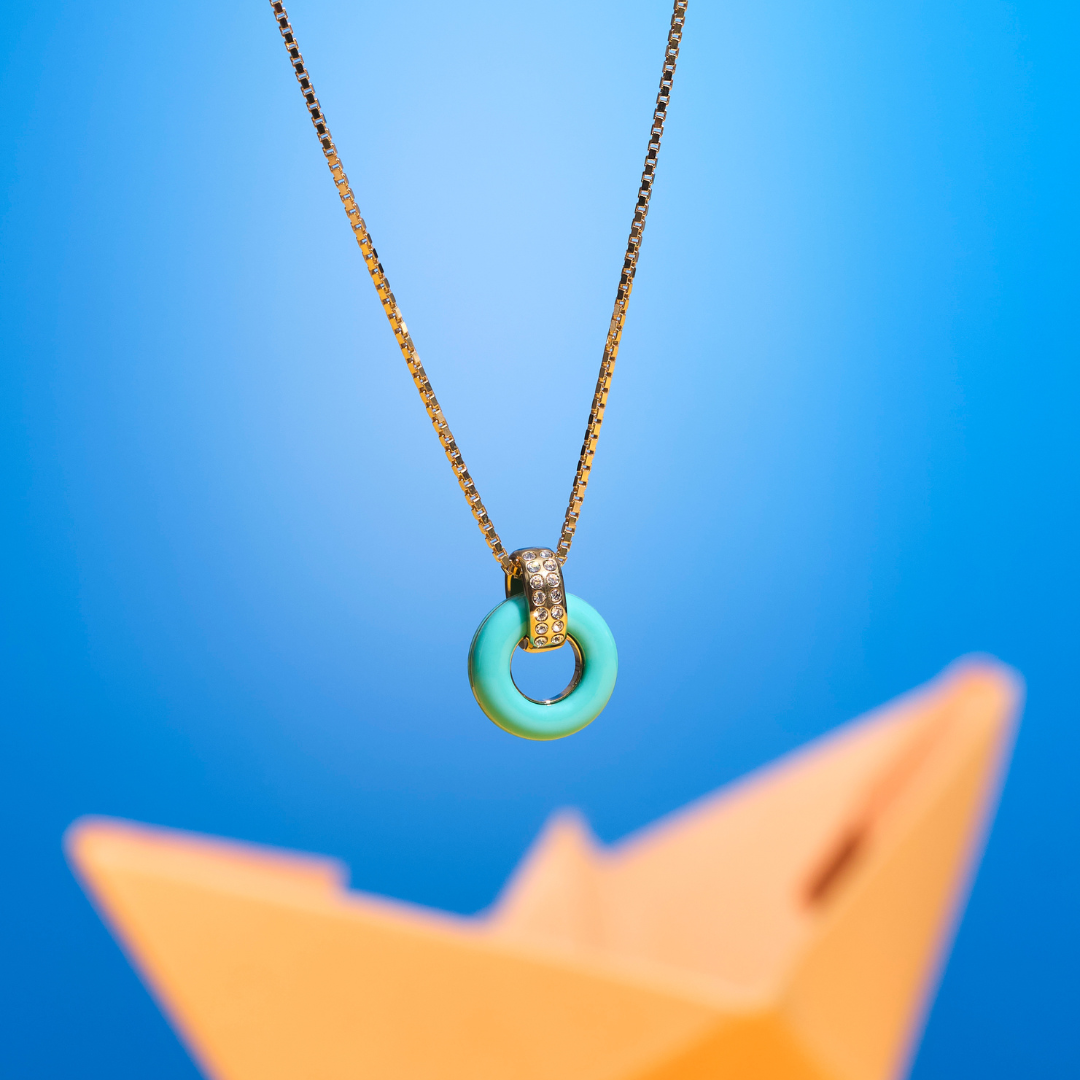 Lifesaver gold necklace with a turquoise circular pendant 