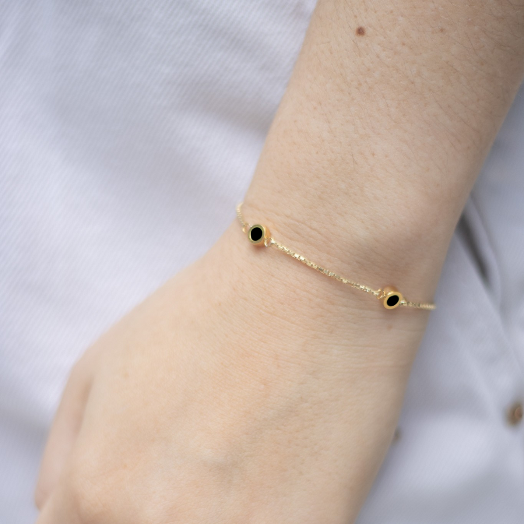 Gold bracelet with minimalist black enamel charms