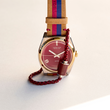 Jason Hyde 34mm watch with red dial, striped strap, and red chain accessory