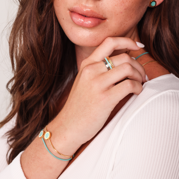 Stylish woman accessorized with Jason Hyde turquoise and gold-tone jewelry.