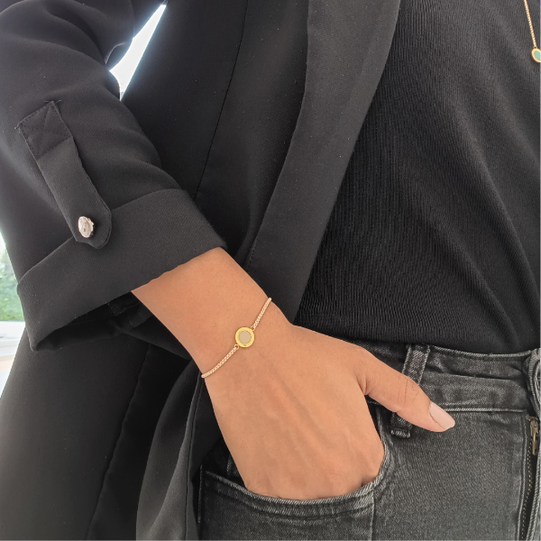 Minimalist beige chain bracelet with circle pendant by Jason Hyde