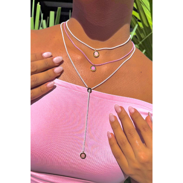 Close-up of a woman wearing three layered Jason Hyde necklaces