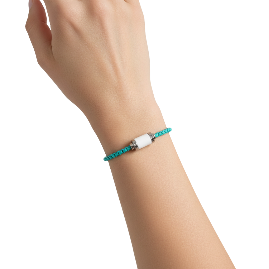 Turquoise braided bracelet with white  cylinder and silver details on a wrist