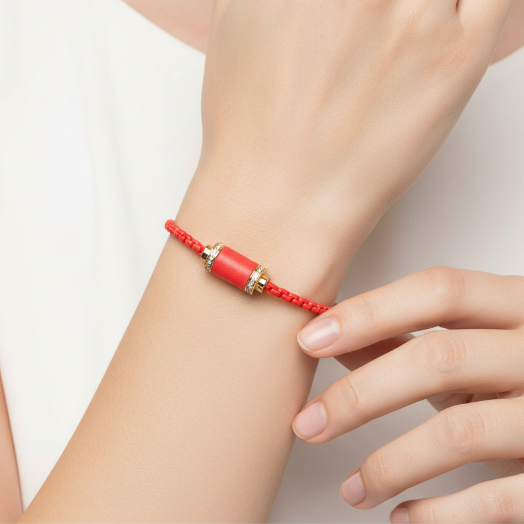 Red string bracelet with bright red cylinder and gold 