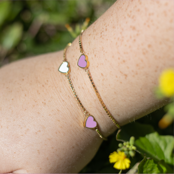 Women’s  gold bracelets with sustainable white and fondant pink heart charms