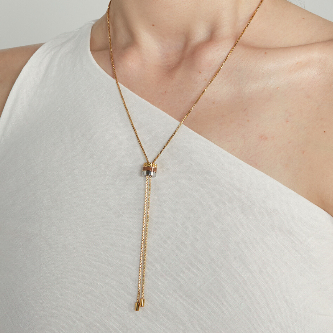 Jason Hyde gold bolo tie necklace with adjustable sliding pendant on woman