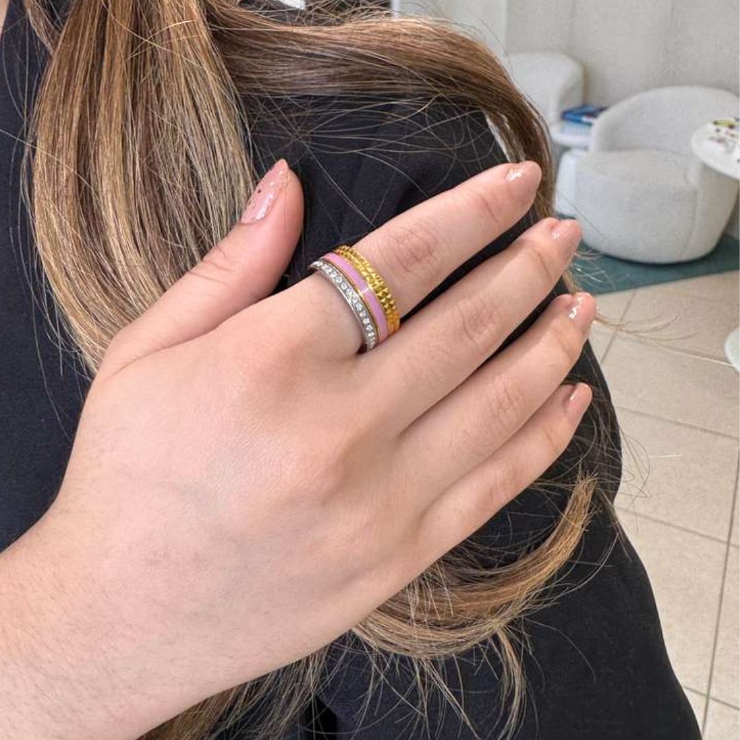 A hand with a pink manicure wearing a Wewa Tube Fondant Pink Ring