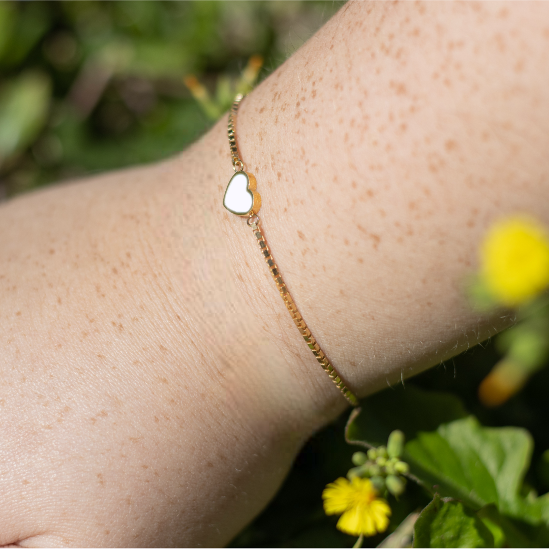 Sustainable gold bracelet with white heart detail, Jason Hyde
