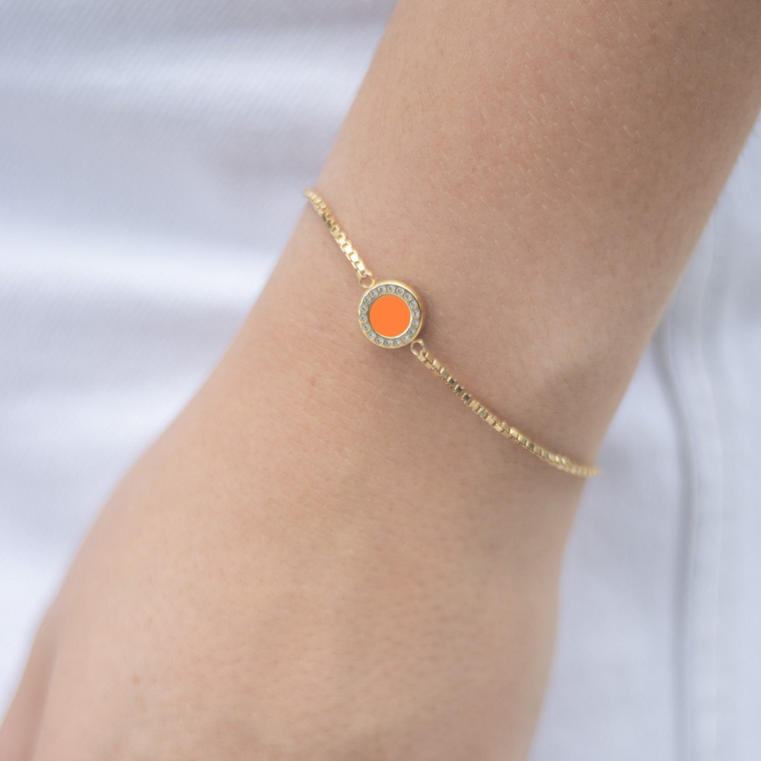 Jason Hyde gold bracelet with vibrant orange round chip and zirconia