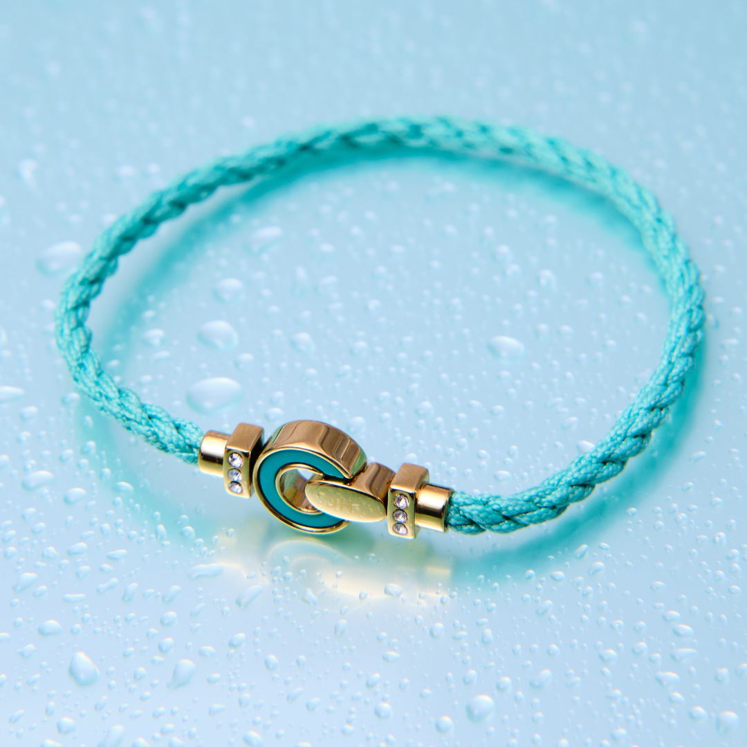 Turquoise braided cord bracelet with gold and blue enamel clasp 