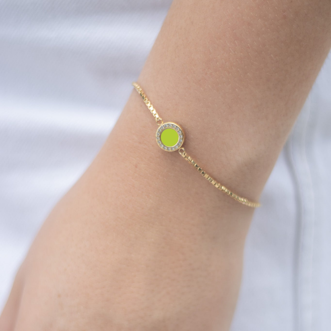 Elegant gold bracelet with vibrant lime green enamel centerpiece and zirconia