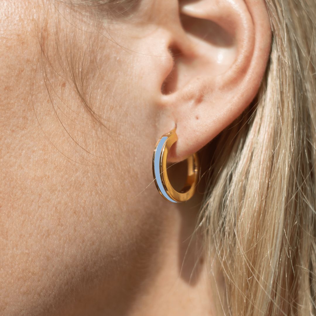 Chunky gold hoop earring with powder blue enamel detail