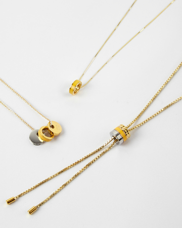 A product shot of three Jason Hyde gold-tone necklaces