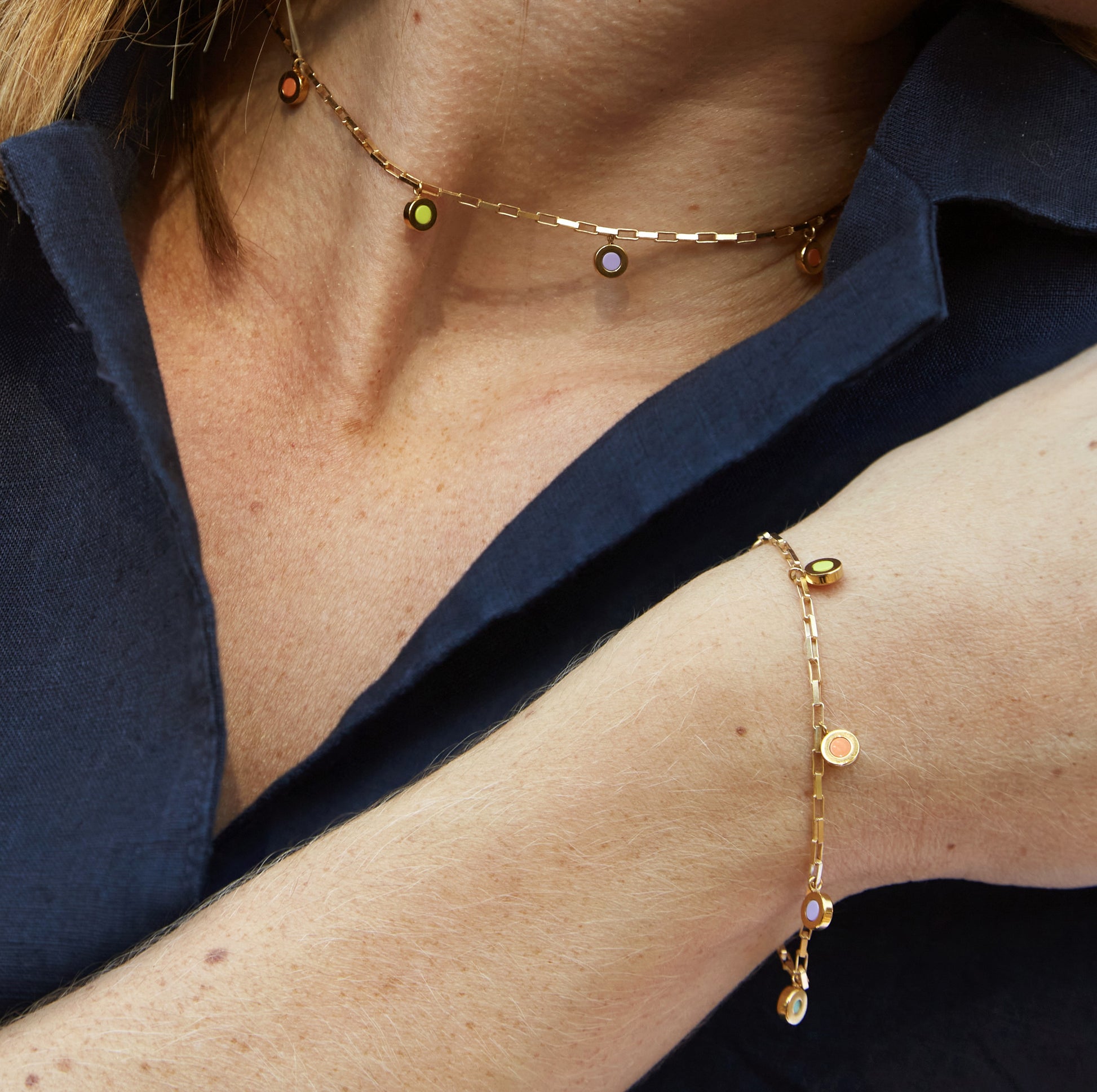 Gold choker and bracelet set with colorful recycled plastic charms, celebrating sustainability in everyday elegance.