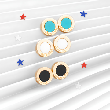 Three pairs of Jason Hyde round gold stud earrings with turquoise, white, and black enamel centers 