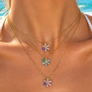 Gold layered necklace with three enamel flower pendants in lavender blue