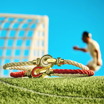 Colorful Jason Hyde jewelry collection displayed on a football stadium field