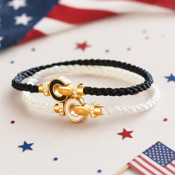 Two Jason Hyde cord bracelets with gold enamel interlock clasps