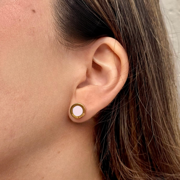 Half of a woman's face showing a zirconia earring by Jason Hyde