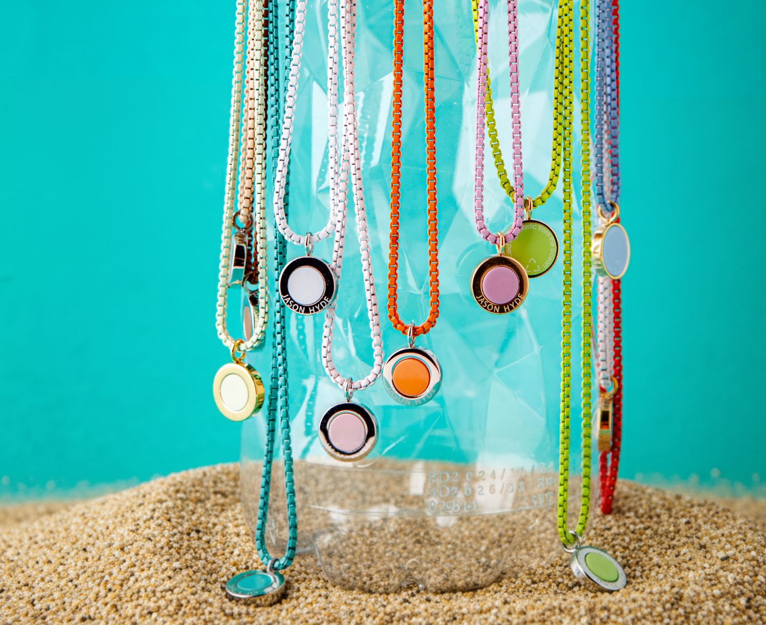 Jason Hyde red chain necklace with silver bottle and circle pendants.