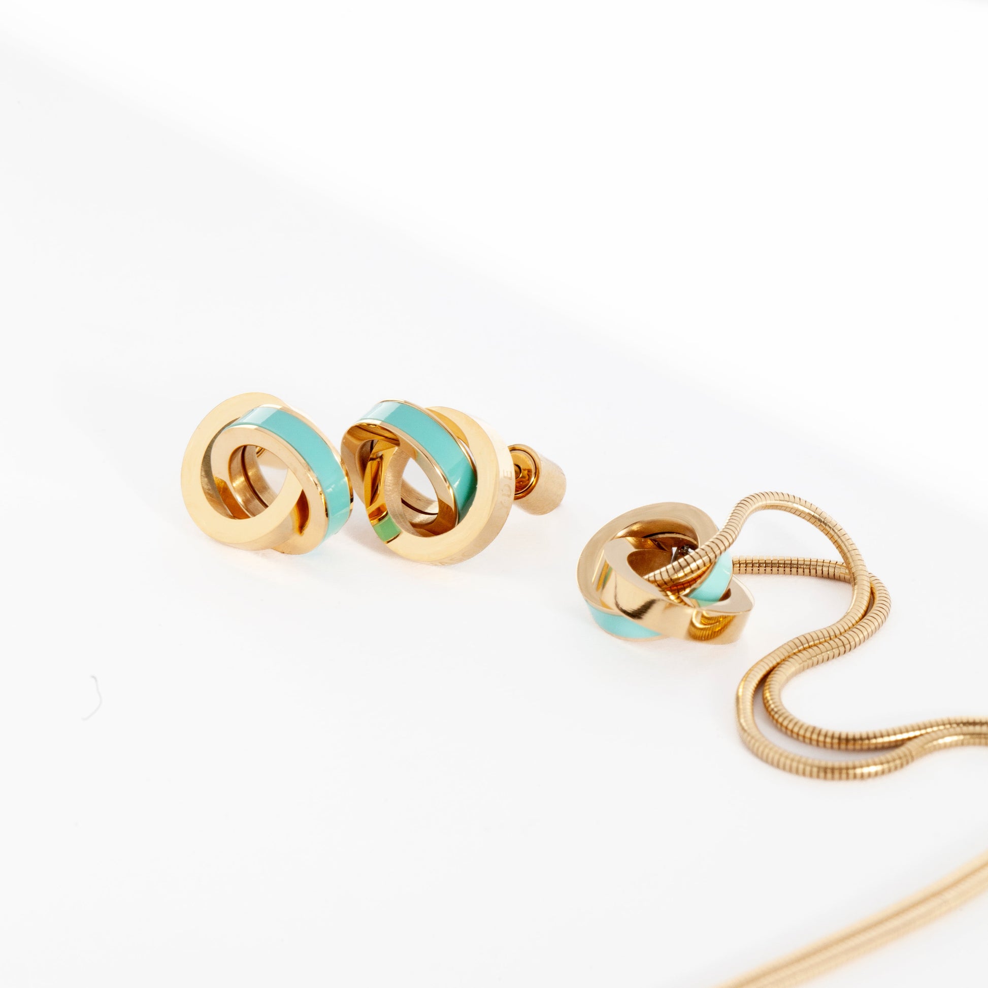 Gold earrings and necklace with turquoise chip.