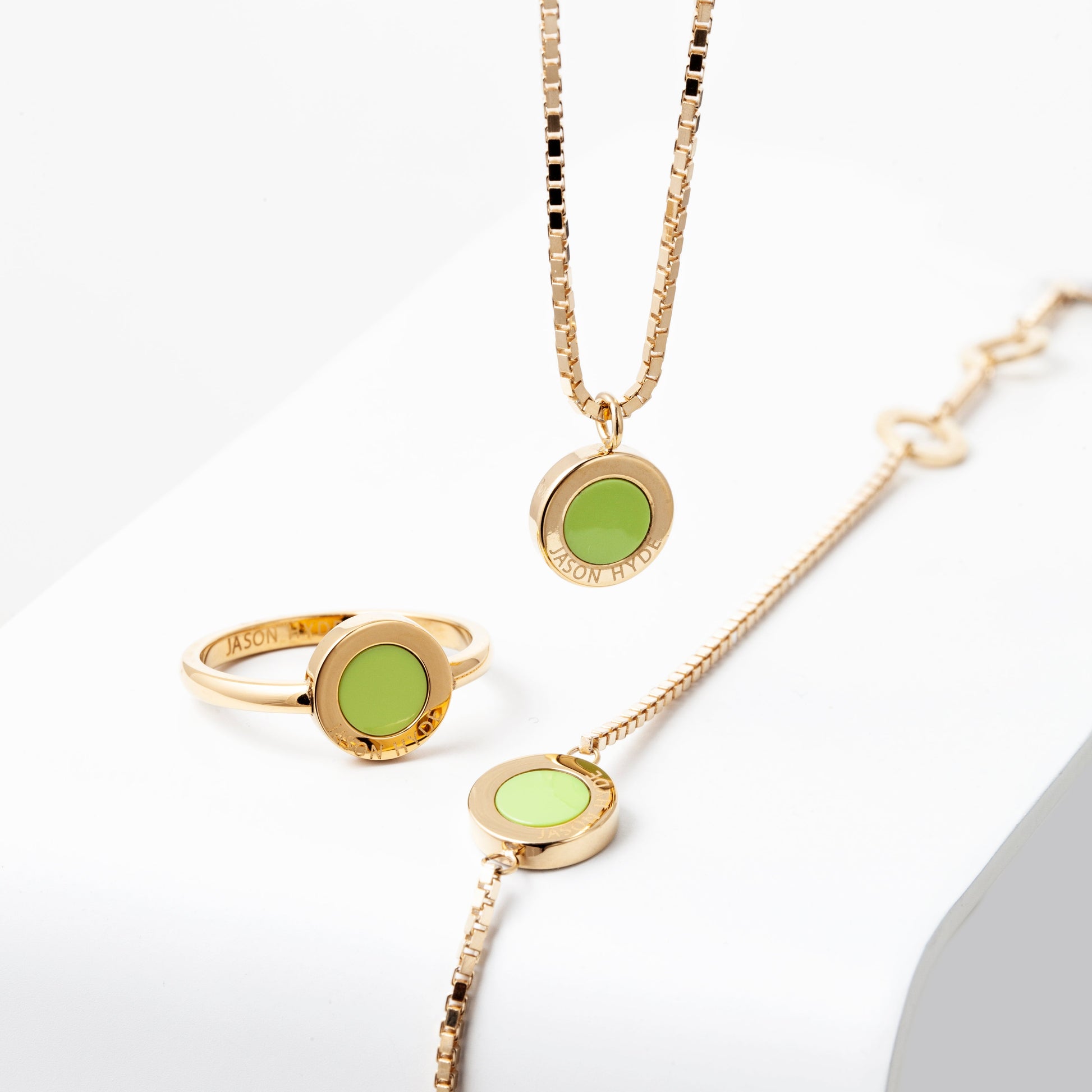 Gold Jason Hyde lime green jewelry set with a ring, necklace, and bracelet 