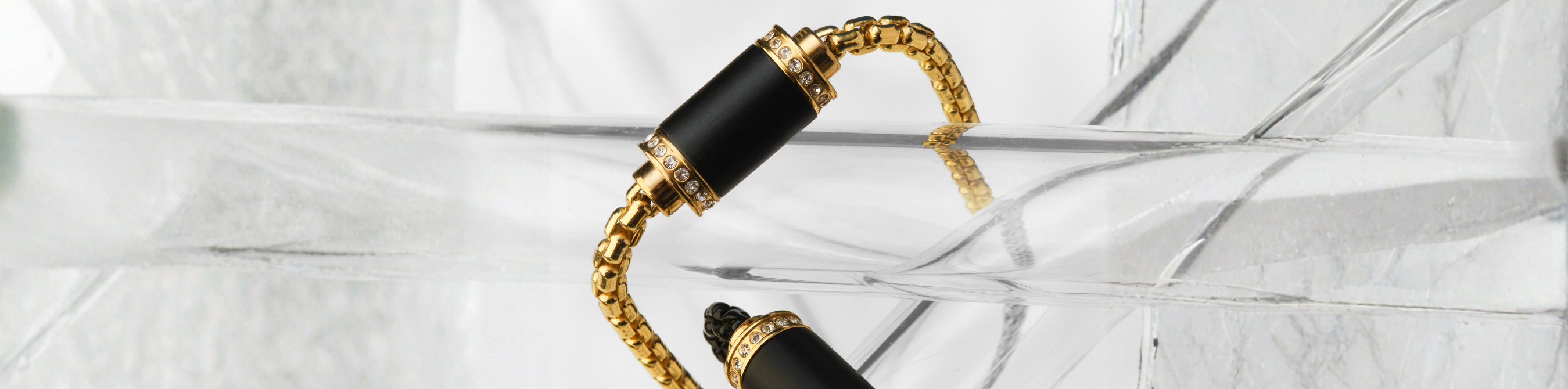 Jason Hyde luxury gold bracelet with black magnetic clasps and crystal pavé details 