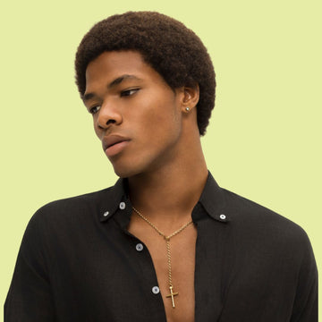 Young man with an afro and a Seacap gold cross necklace.
