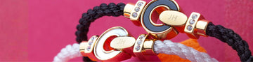 Two bracelets with gold, crystal-studded clasps engraved with 'JH'