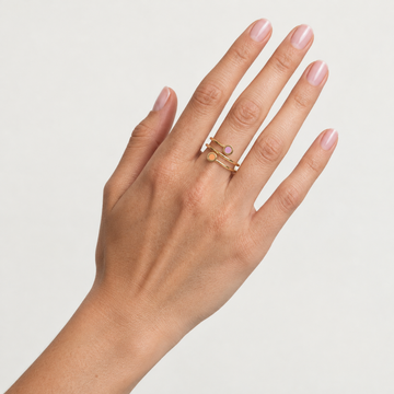 Hand wearing Jason Hyde New Wave gold double ring with fondant pink and apricot crush chips