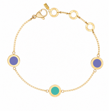 Gold chain bracelet with two circular Persian blue charms and a turquoise charm.