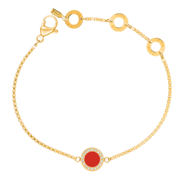 Gold chain bracelet with a red circular charm by Jason Hyde.