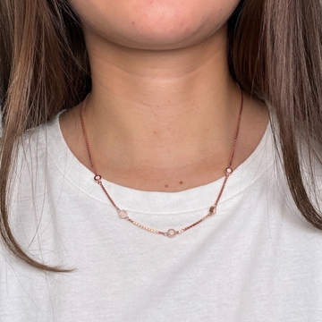 Jason Hyde rose gold station necklace with recycled pink plastic charms worn by a model.