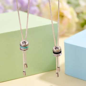 Two silver box chain lariat necklaces with cylindrical slider charms in turquoise and black enamel