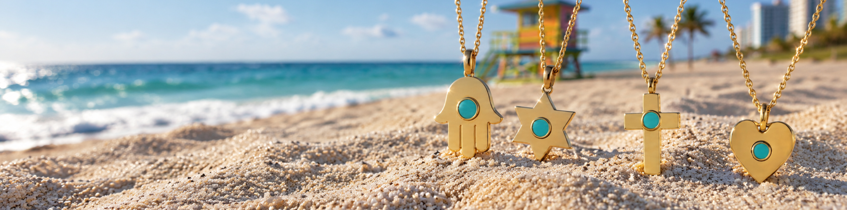 Four Jason Hyde gold pendant necklaces with turquoise ocean plastic chips standing on beach sand