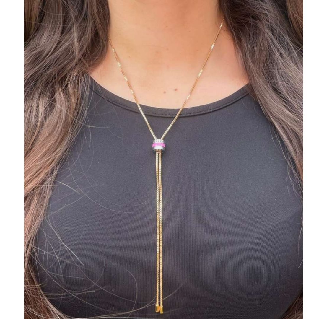 Jason Hyde gold lariat necklace with a sliding pink recycled plastic charm and pavé details.