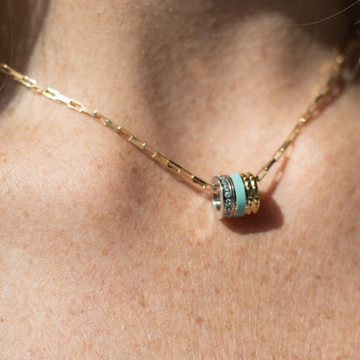 Jason Hyde gold necklace with turquoise, gold and silver cylindrical pendant.