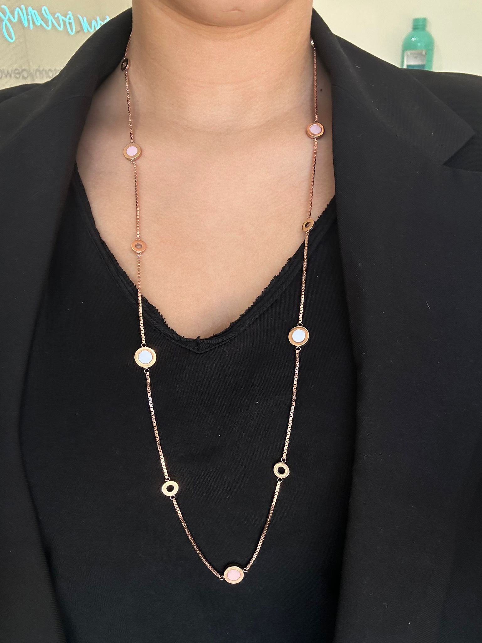 Long Jason Hyde rose-gold necklace with multiple round white-inlaid and open circle charms