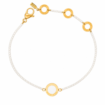 White chain bracelet with a matching circular enamel charm
