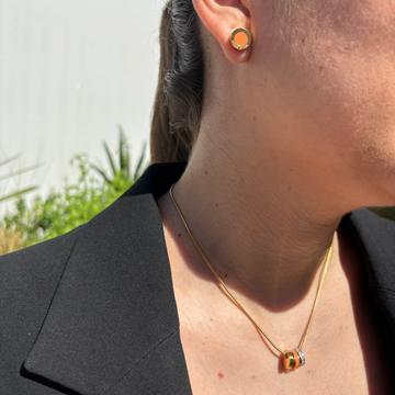 Woman wearing a Ocean orange chip earring and a Wewa Necklace 