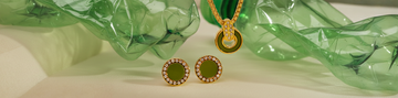 Gold jewelry set featuring green enamel