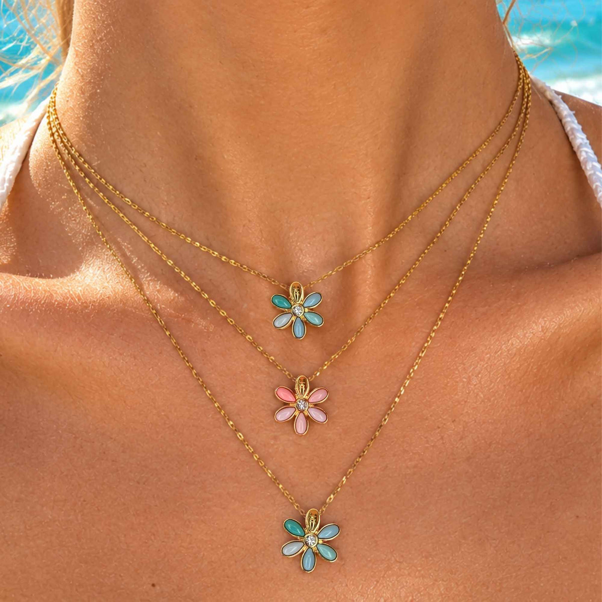 Gold-tone necklace with turquoise flower charms and small pink and blue accents